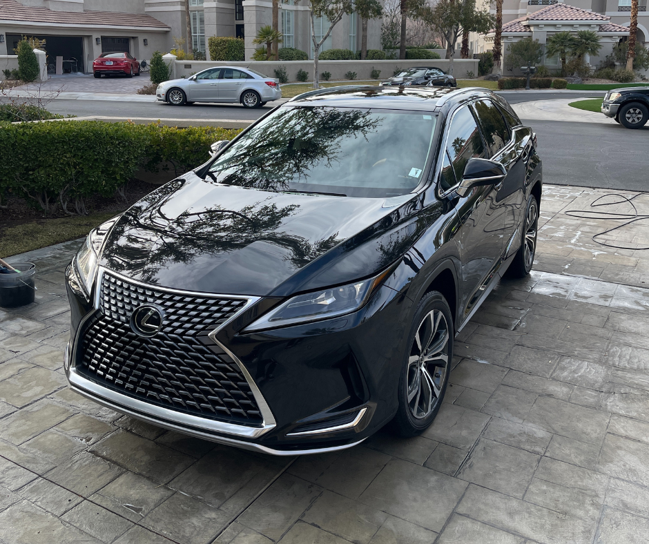 Black Lexus RX freshly detailed in a driveway